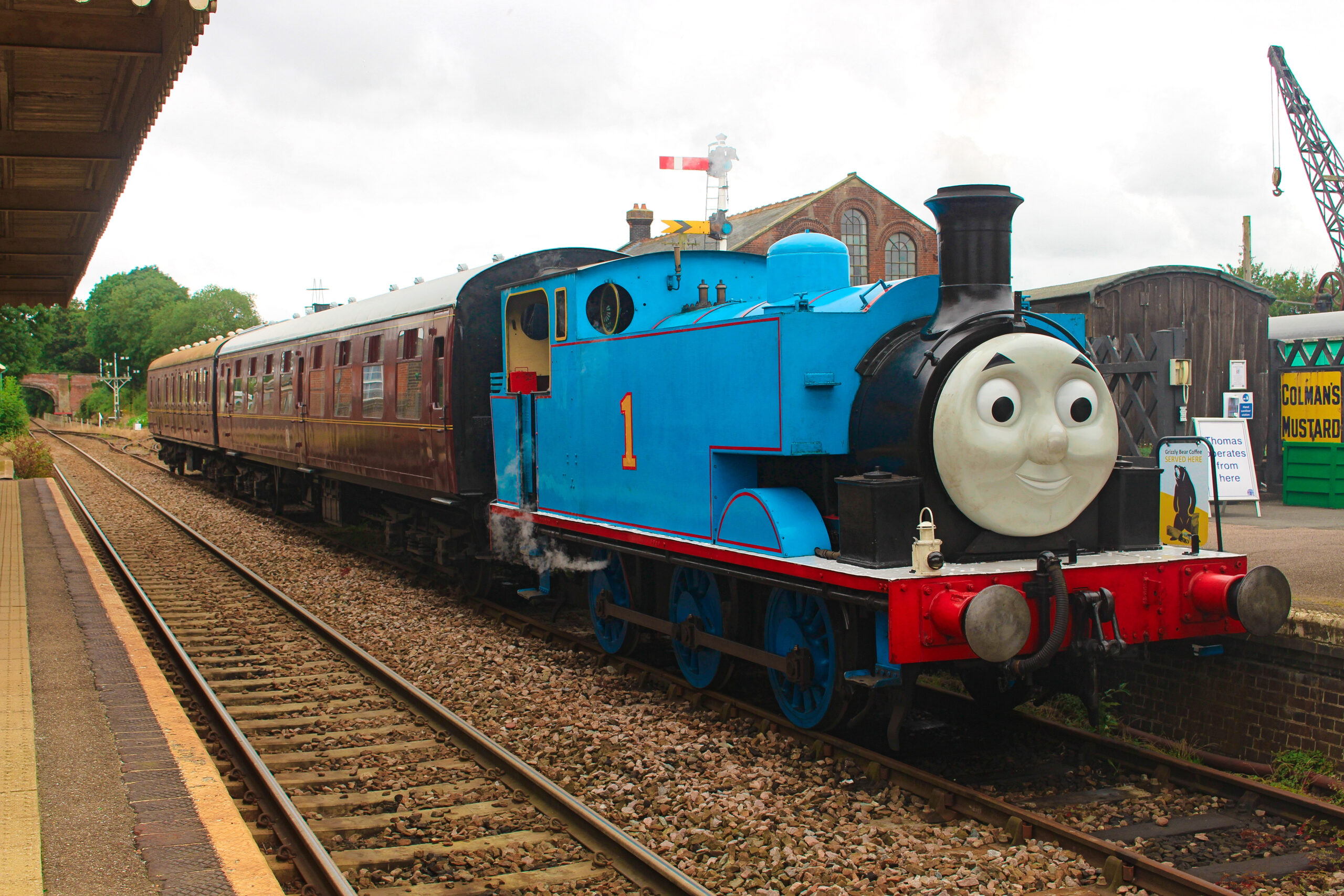 Freight Train With Red Engine Pulling Out Of Station Stock Photo